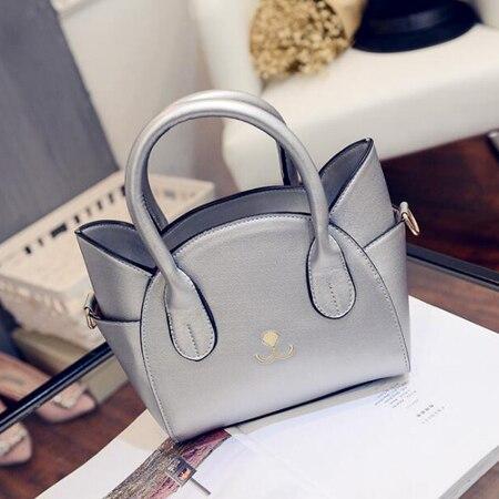 Silver women's shoulder bag with a unique cat design, an elegant faux leather feline fashion accessory.