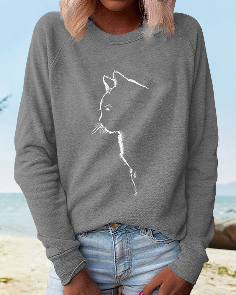 Graphic women's round neck sweatshirt featuring a fun cat print. Loose fit & long sleeve for comfort.