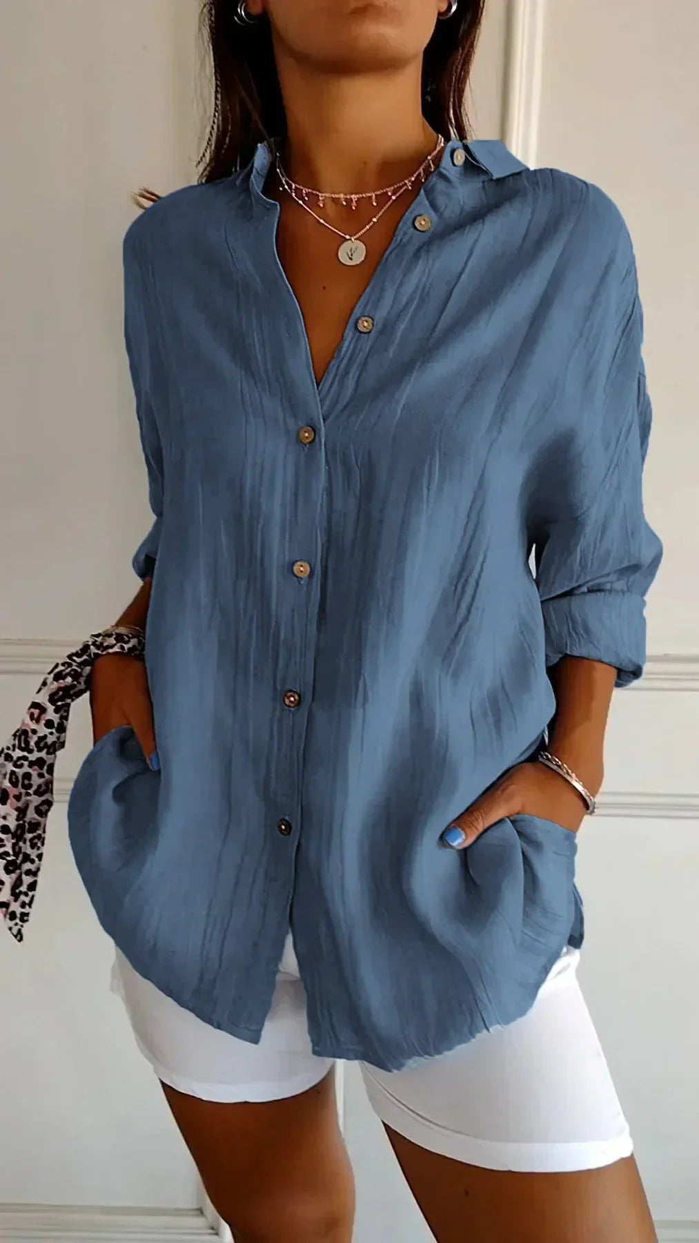 Close-up of a women's Elodie pleated lightweight blouse fabric, highlighting its texture and flow.