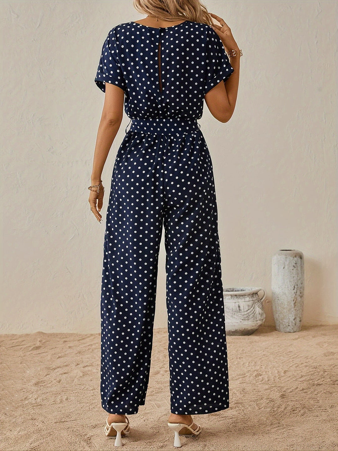 Lightweight and breathable women's jumpsuit with a fun polka dot pattern and flattering elastic waist.