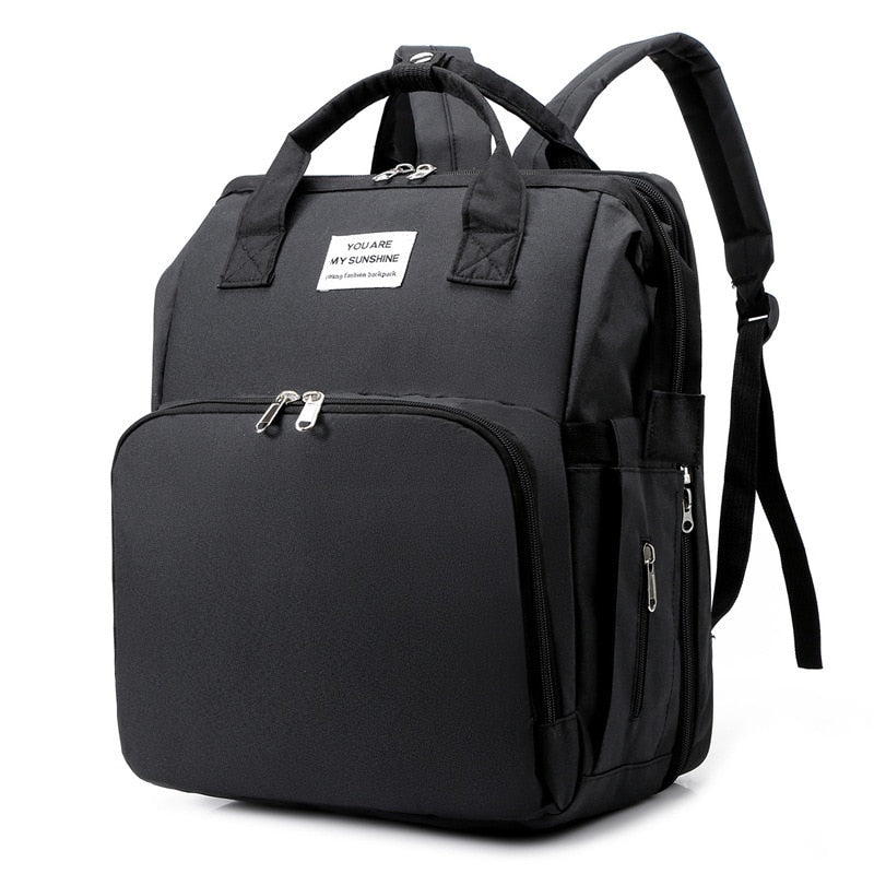Women's portable baby bed & diaper bag travel backpack, multi-function for infant care.