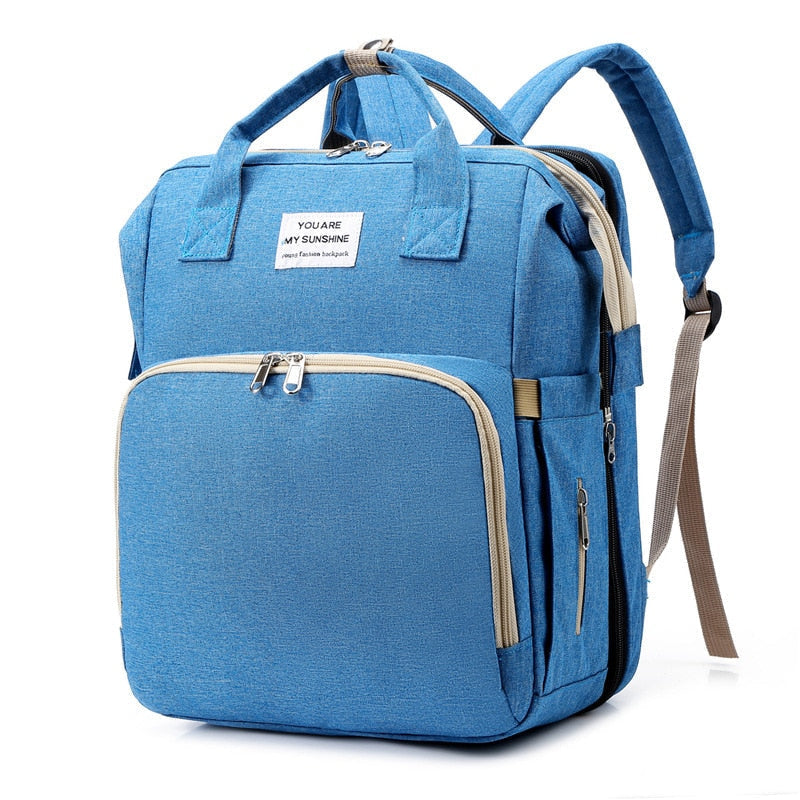 Open portable baby bed & changing station feature of multi-function diaper bag backpack.