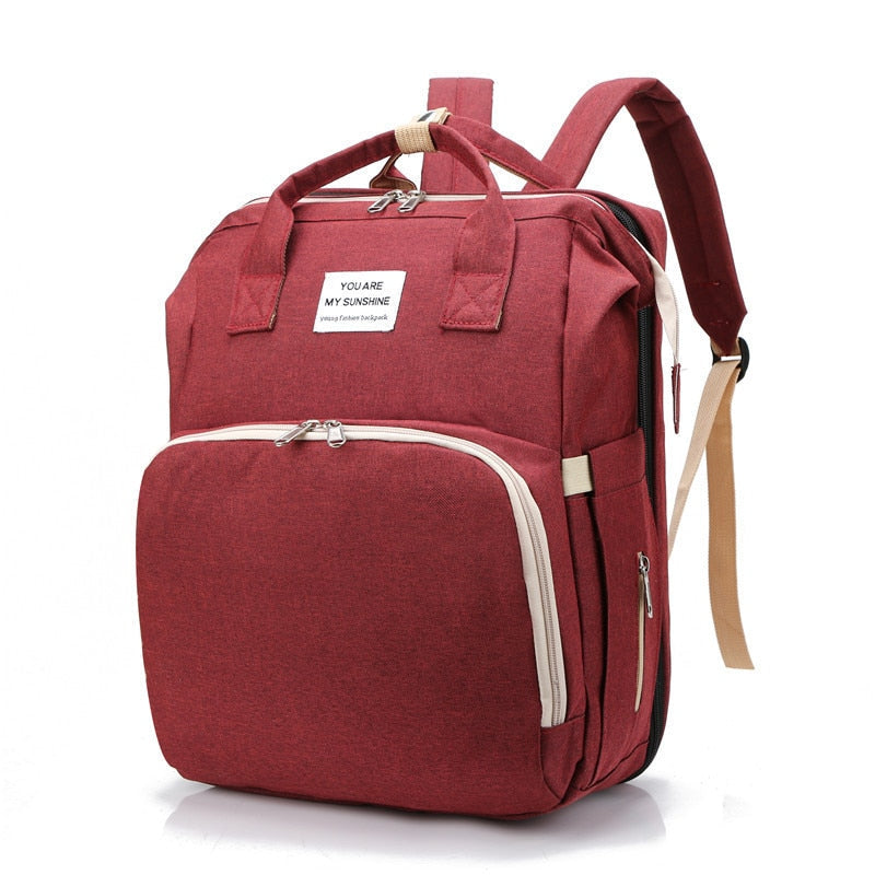 Travel-friendly baby gear: portable infant bed & spacious diaper bag for adventurous parents.