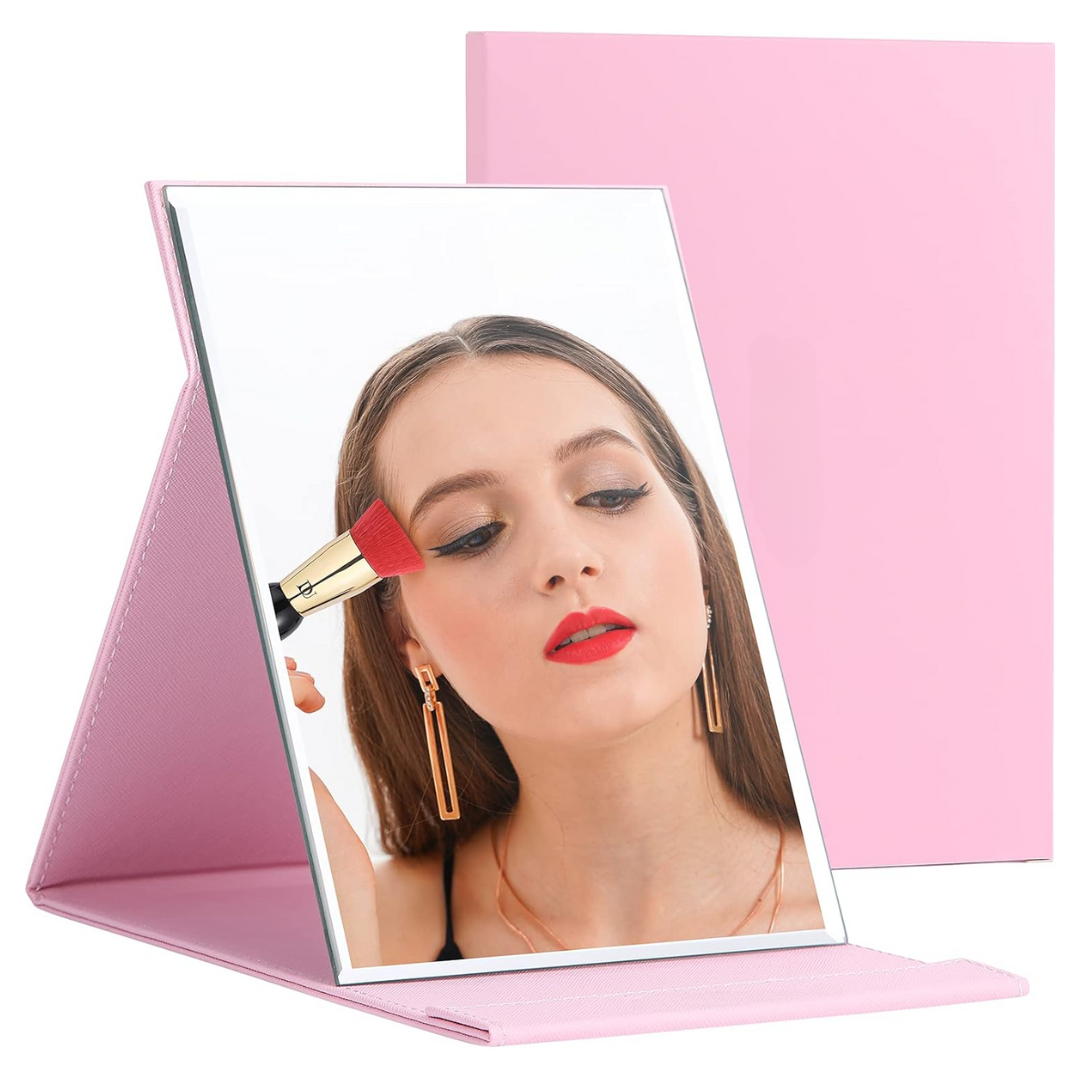 Portable compact makeup mirror for women with adjustable stand, ideal travel beauty essential.