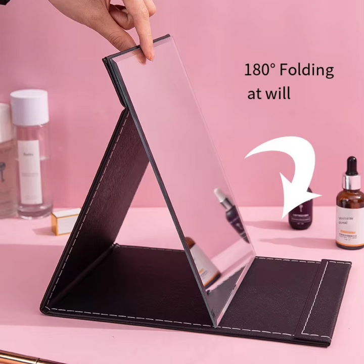 Travel compact mirror for women with adjustable stand, essential portable beauty accessory.