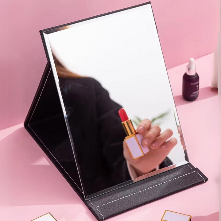 Women's compact mirror with sturdy adjustable stand, a versatile portable beauty essential for makeup.