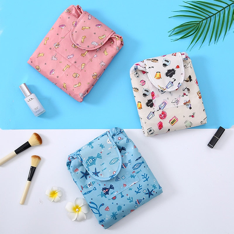 Stylish grey flamingo drawstring makeup organizer. Portable cosmetic travel bag for women's essentials.