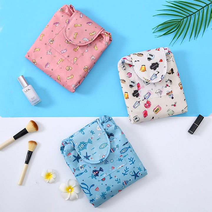 Stylish grey flamingo drawstring makeup organizer. Portable cosmetic travel bag for women's essentials.