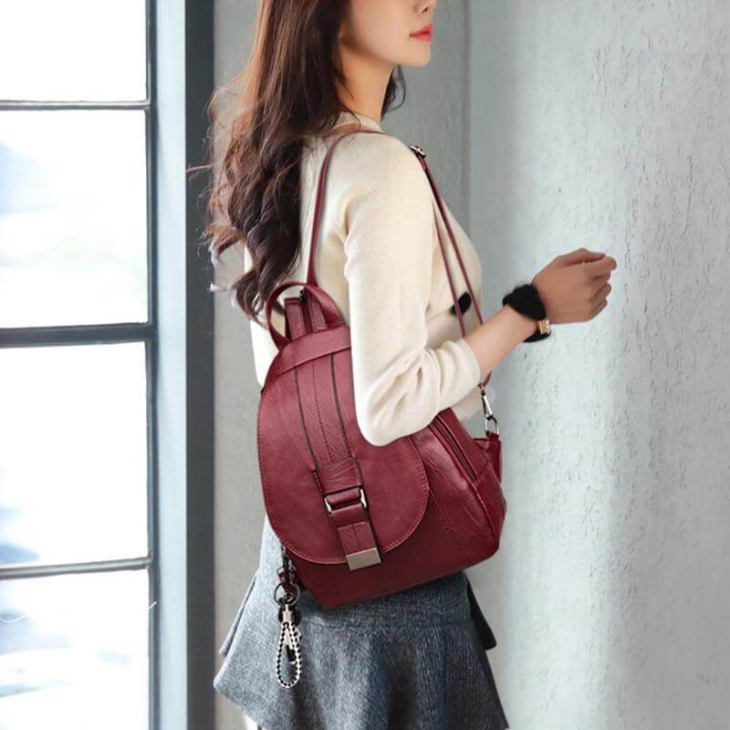 Women's water-resistant leather backpack with multiple compartments, designed for organization.
