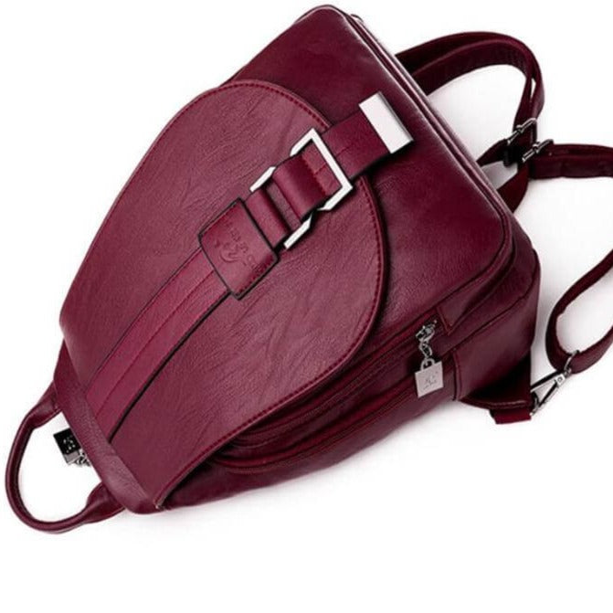 Close-up of a women's premium water-resistant leather backpack texture and stitching detail.