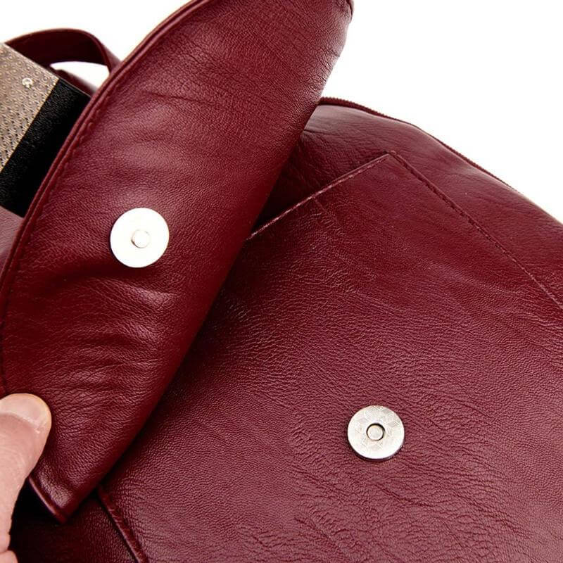 Side profile of a women's water-resistant leather backpack, showcasing its sleek design.