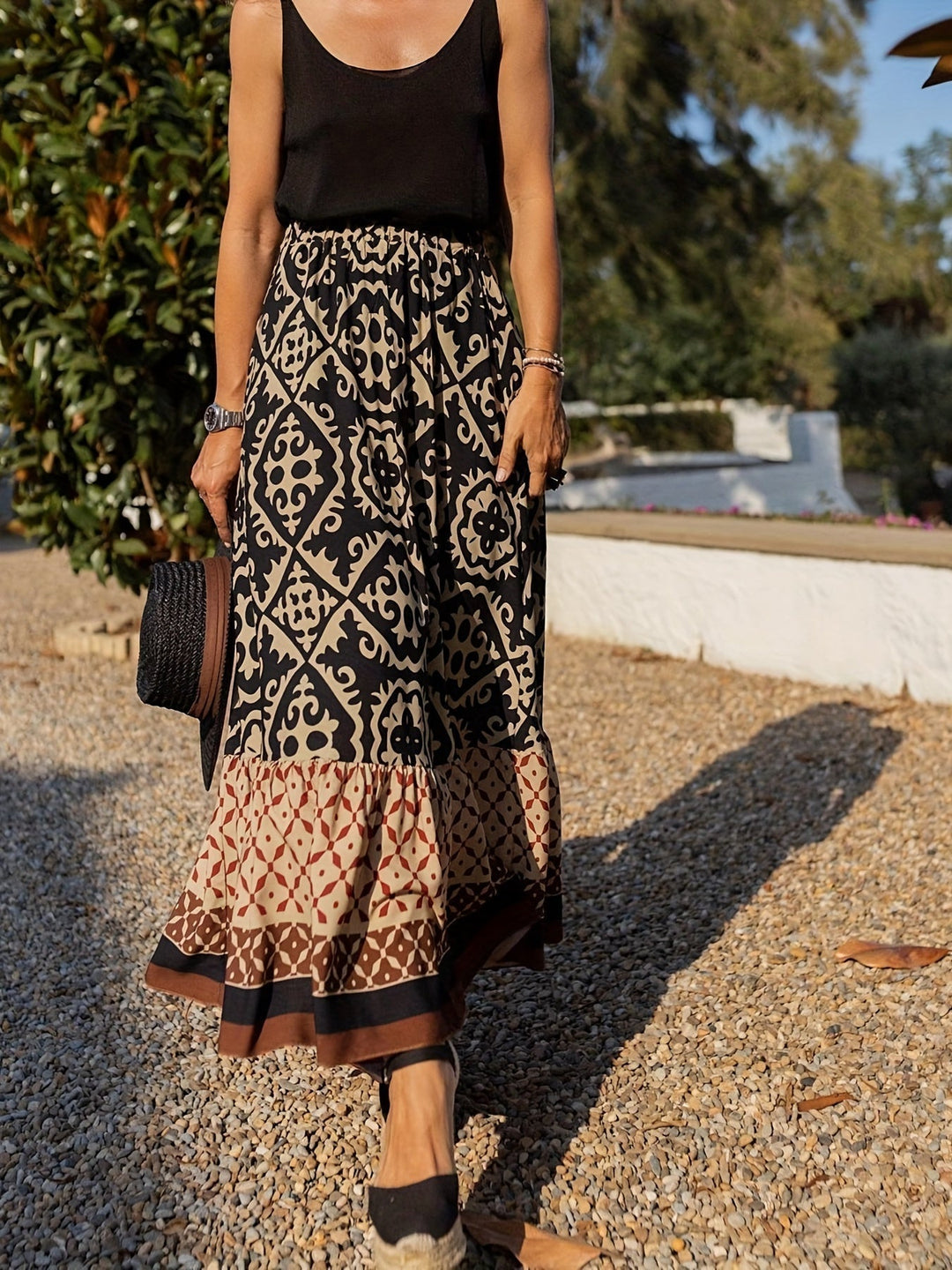 Summer fashion women's boho skirt, vibrant print, long flowing fringe accents.