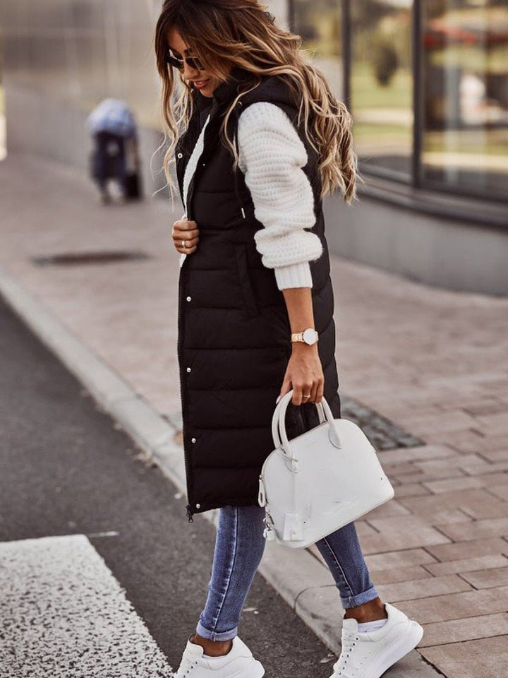 Stylish women's knee-length quilted gilet, perfect for fall fashion & cozy winter outerwear.