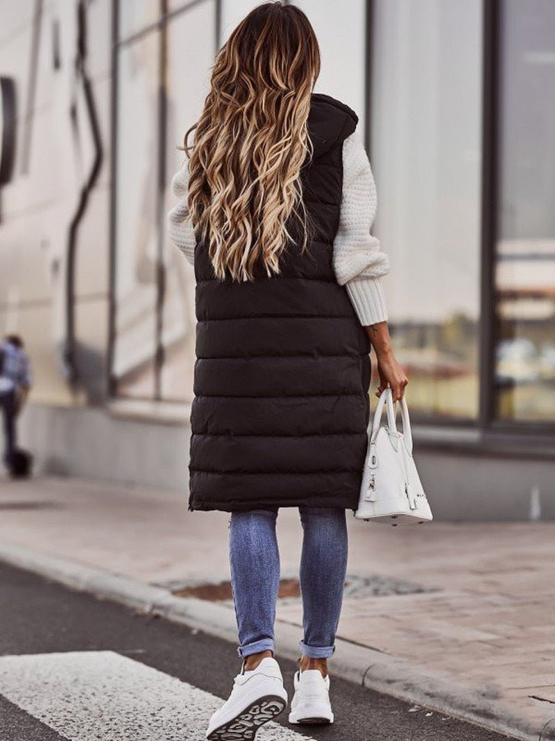 Versatile women's knee-length quilted vest, an essential for layering in cold weather & chic outfits.