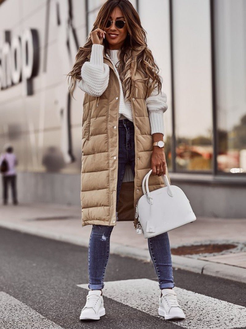 Women's sleek black quilted bodywarmer, knee-length, offering winter warmth & modern casual style.