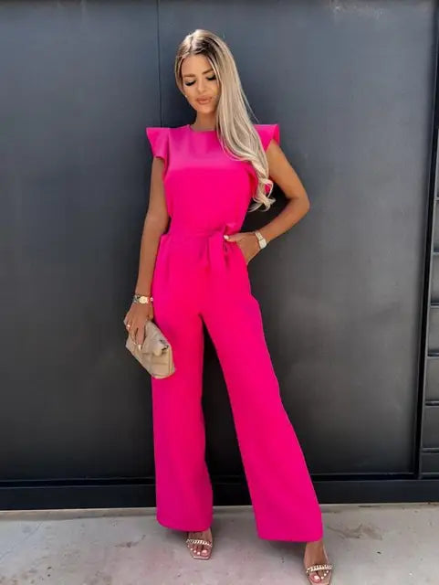 Fashionable ruffled jumpsuit for women featuring wide legs and a flattering tie waist. Effortless chic style.