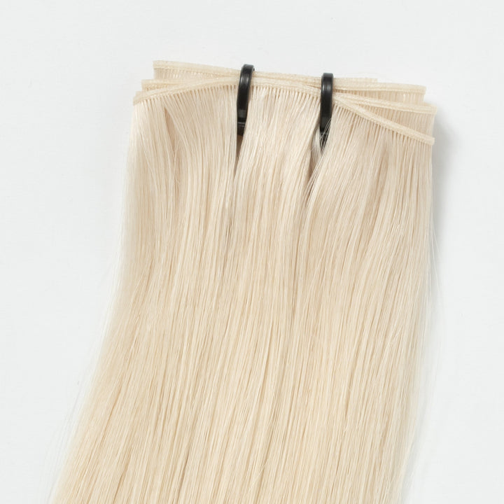 Women's seamless Light Ash Blonde 60B hair extensions. Invisible weft for natural volume, length & beauty.