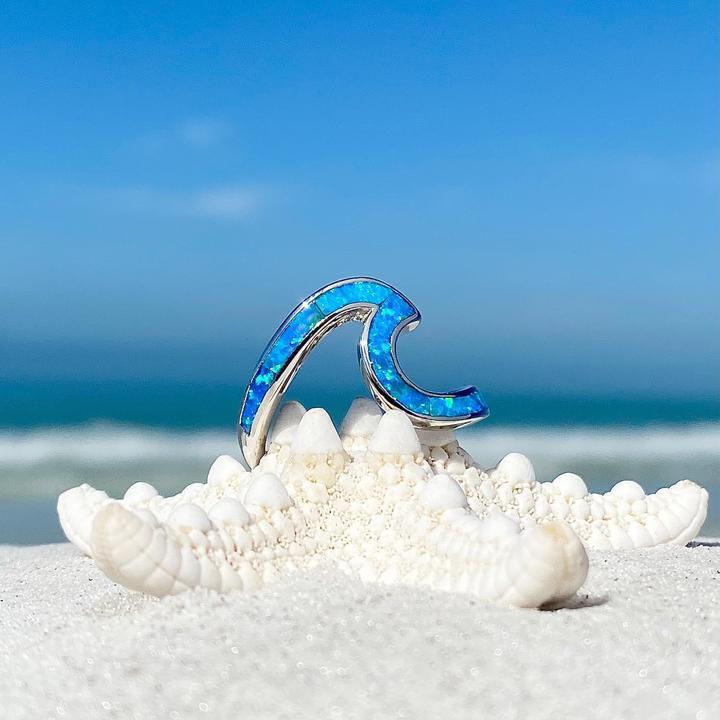 Detailed women's silver sea wave ring with captivating blue opal gemstone, perfect ocean jewelry.