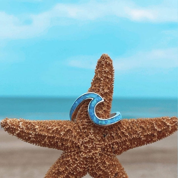 Handmade silver sea wave ring for women, showcasing a beautiful blue opal gemstone, ocean style.