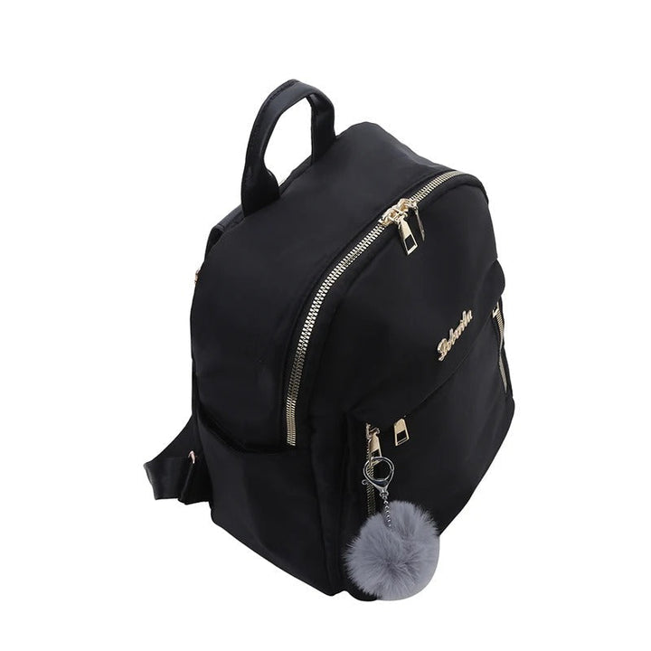 Woman wearing a black PU leather travel backpack, showcasing its fashion accessory appeal.