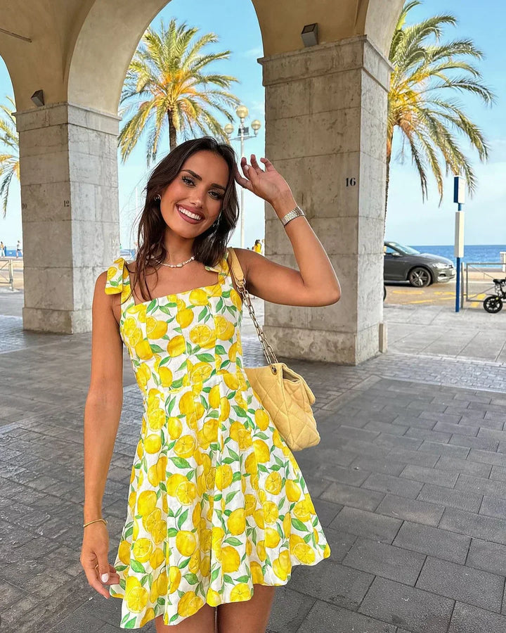 Women's sleeveless lemon print summer dress, cheerful and casual. Perfect for vacation, beach, or a day out.