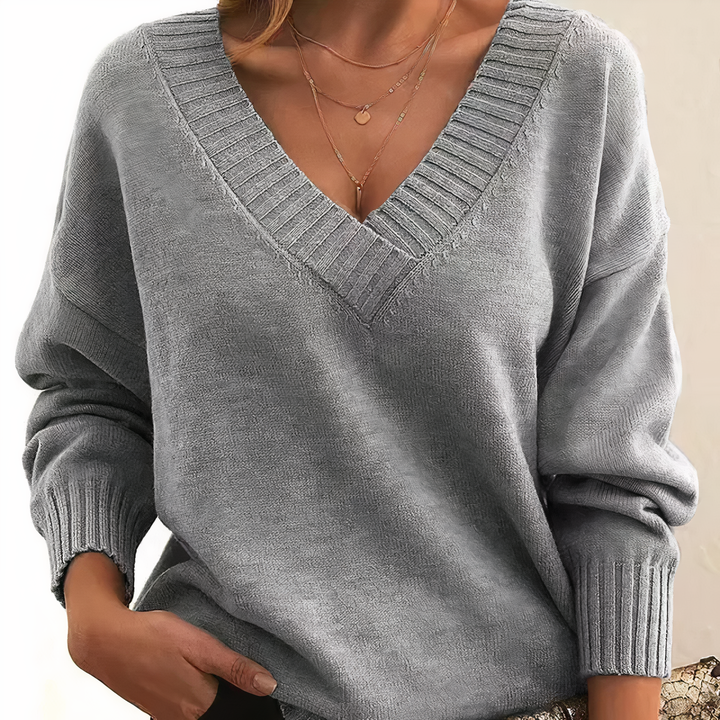 Warm women's V-neck long-sleeve sweater, a soft and comfortable knit top for cold weather.