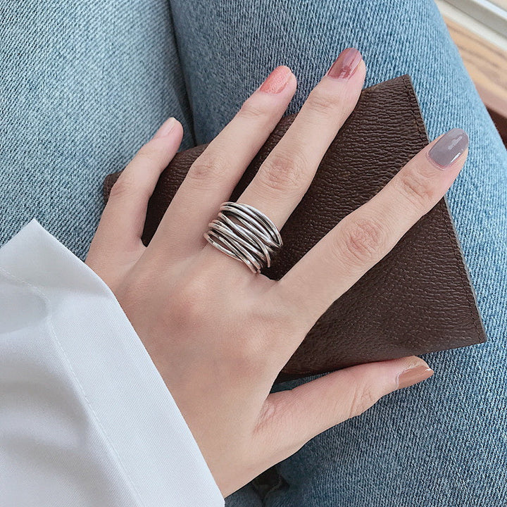 Adjustable silver layered ring for women, elegant and modern sterling silver jewelry piece.