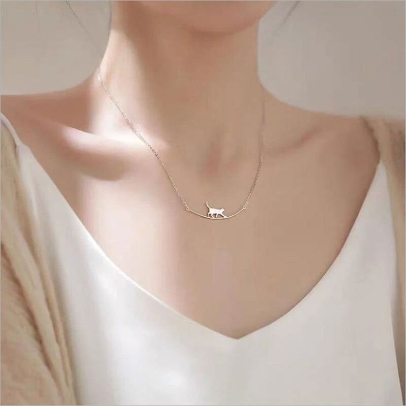 Delicate sterling silver climbing cat pendant necklace, a charming animal jewelry piece for women.