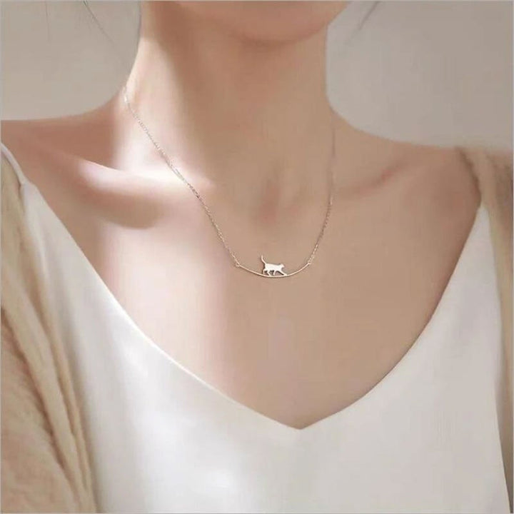 Delicate sterling silver climbing cat pendant necklace, a charming animal jewelry piece for women.