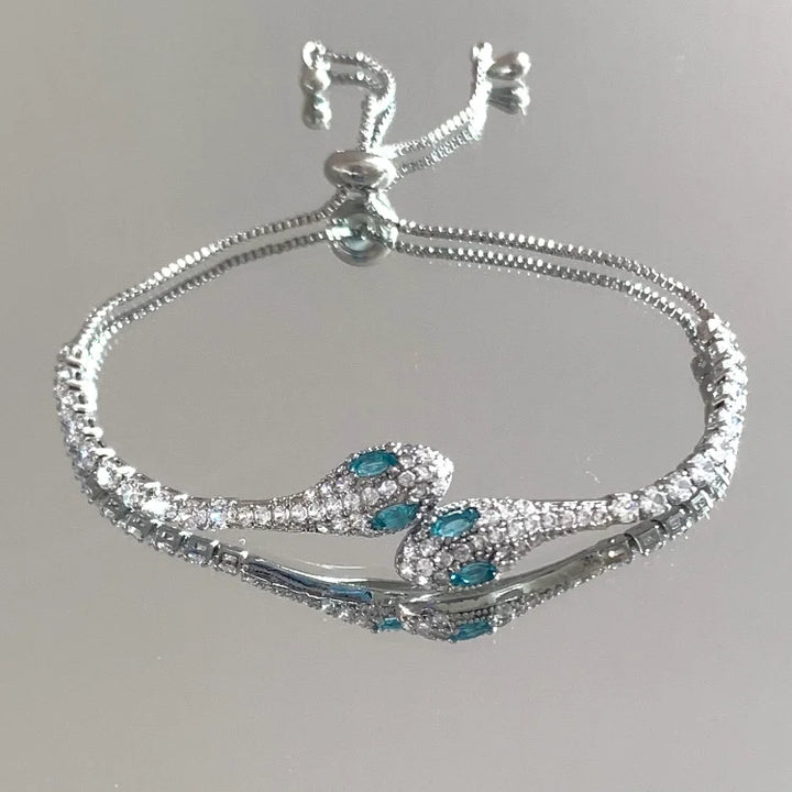 Elegant silver snake bracelet for women, featuring dazzling zirconia eyes and scale texture for mystique.