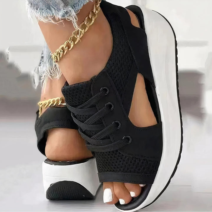 Fashionable women's lace-up wedge sandals featuring an open toe & chic strappy design for summer.