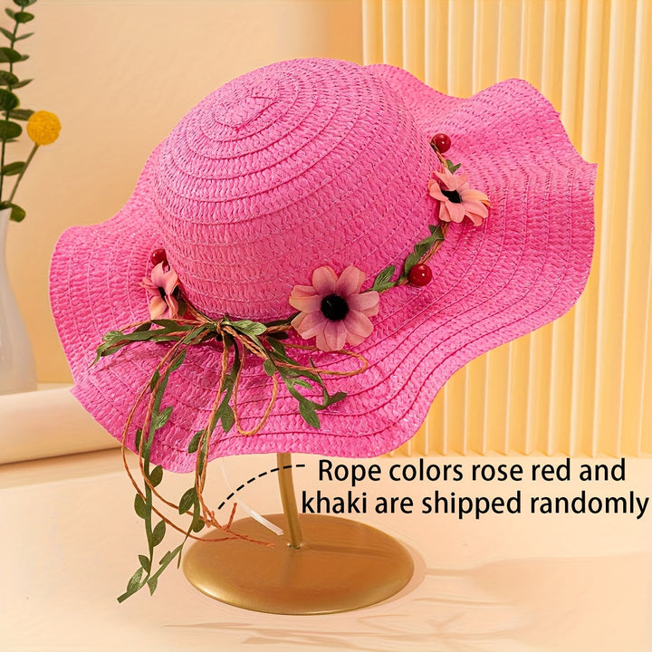 Close-up of women's straw sun hat showing intricate floral & fruit embellishments.
