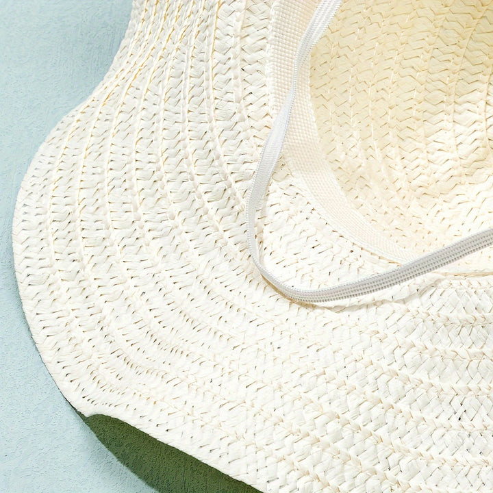 Side view of women's wide-brim straw hat with beautiful floral & fruit details, summer ready.