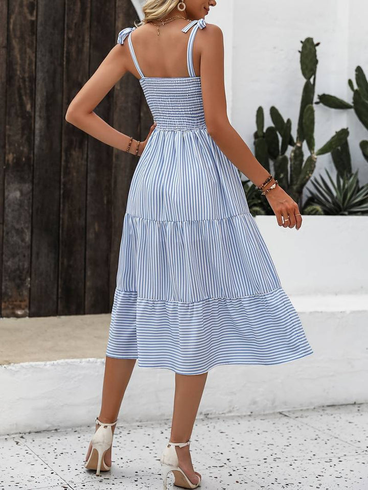 Flared women's striped summer dress with adjustable straps. A timeless sleeveless midi style for beach & casual fashion.