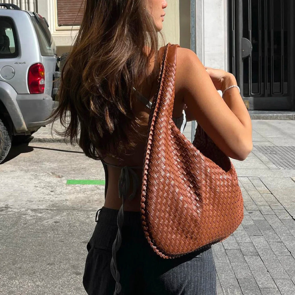 Front view of a classic braided woven women's shoulder bag, chic and spacious for everyday.