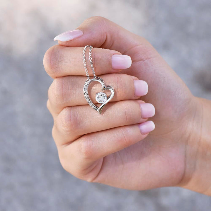 Stylish women's gold heart necklace, symbolizing love. Romantic anniversary jewelry gift for her.