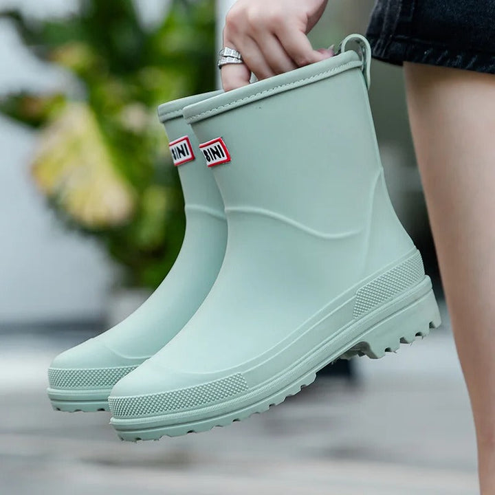 Elegant mid-calf waterproof rain boots for women. Perfect stylish footwear for rainy days.