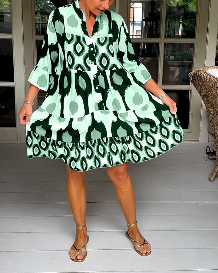 Vibrant abstract print casual dress for women, with comfortable 3/4 sleeves and a relaxed fit.