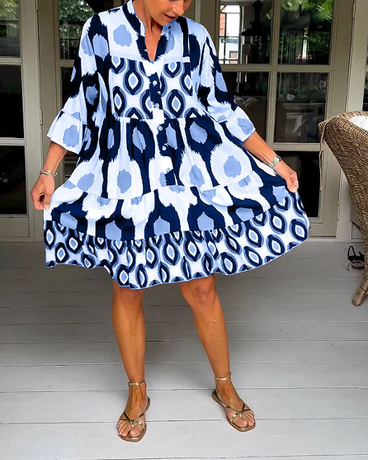 Stylish women's tiered dress, abstract print, 3/4 sleeves, and a practical button placket.