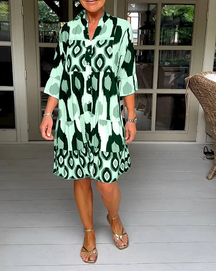 Comfortable women's 3/4 sleeve dress featuring a vibrant abstract print and a relaxed, loose fit.