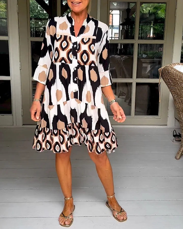 Vibrant abstract print women's summer dress with 3/4 sleeves, ideal for casual and trendy styles.