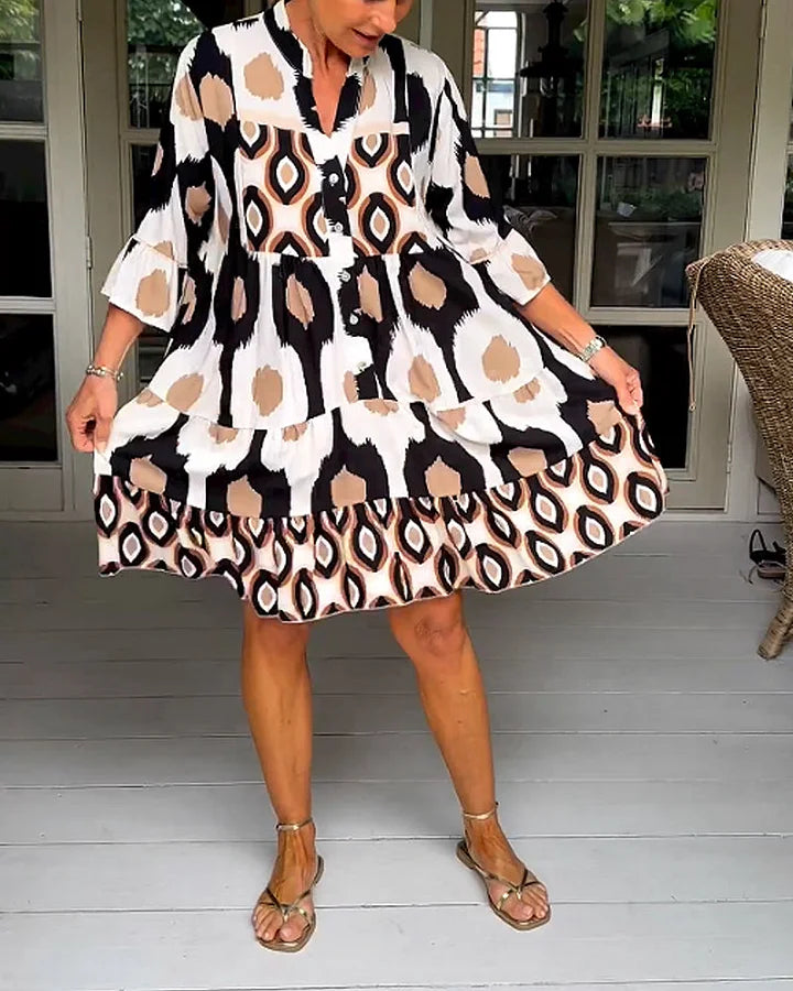 Comfortable women's dress with abstract print, 3/4 sleeves, and button placket for a trendy look.