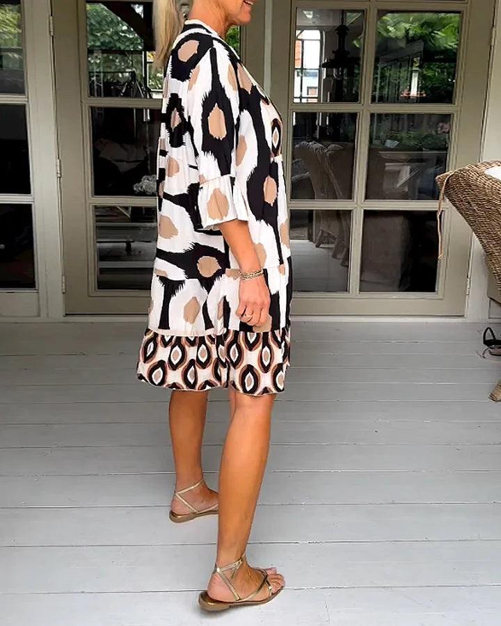 Lightweight summer women's dress with an abstract print, loose fit, and elegant 3/4 sleeves.