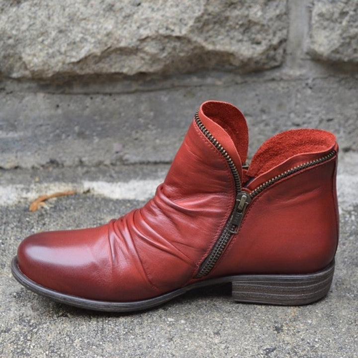 Eva women's trendy leather ankle boots. Modern style with convenient zipper. Sleek fashion footwear.