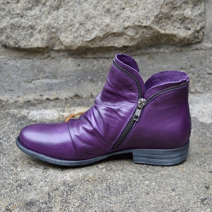 Sleek women's trendy leather ankle boots featuring a practical zipper. Versatile modern footwear for any outfit.