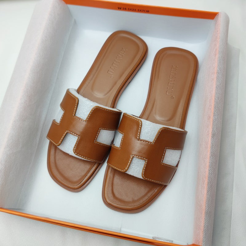 Women's trendy H-profile slide sandals, comfortable open-toe flat footwear for chic summer style.