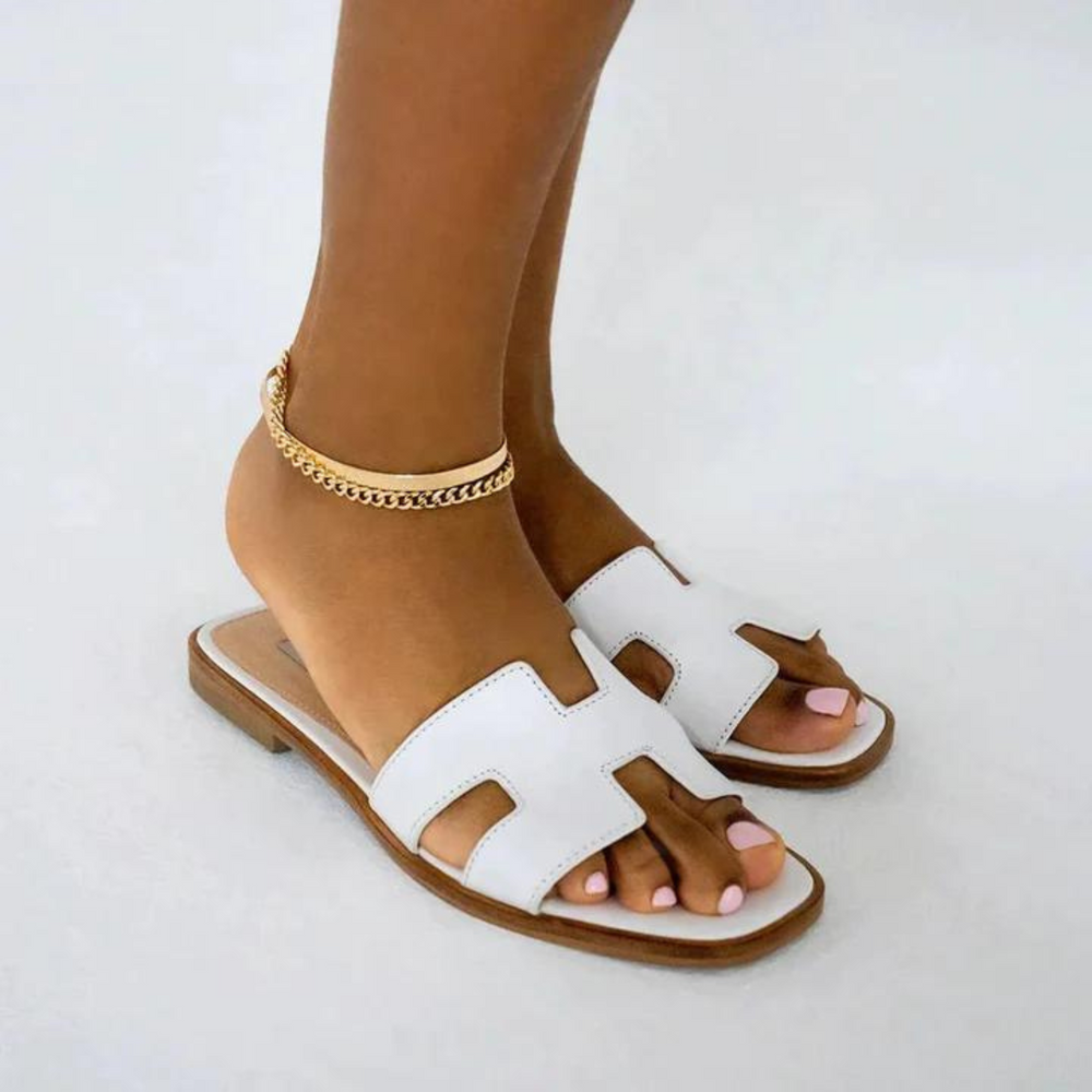 Elegant open-toe H-profile slide sandals for women, flat and fashionable summer footwear.