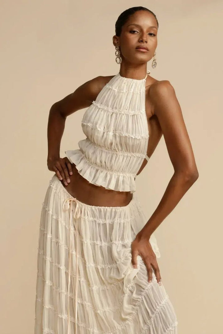 Women's trendy summer two-piece set with halter top and flowy maxi skirt, perfect for vacation wear.