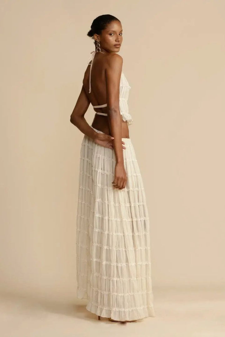 Elegant women's summer two-piece set featuring a sleeveless halter top and a long pleated maxi skirt.
