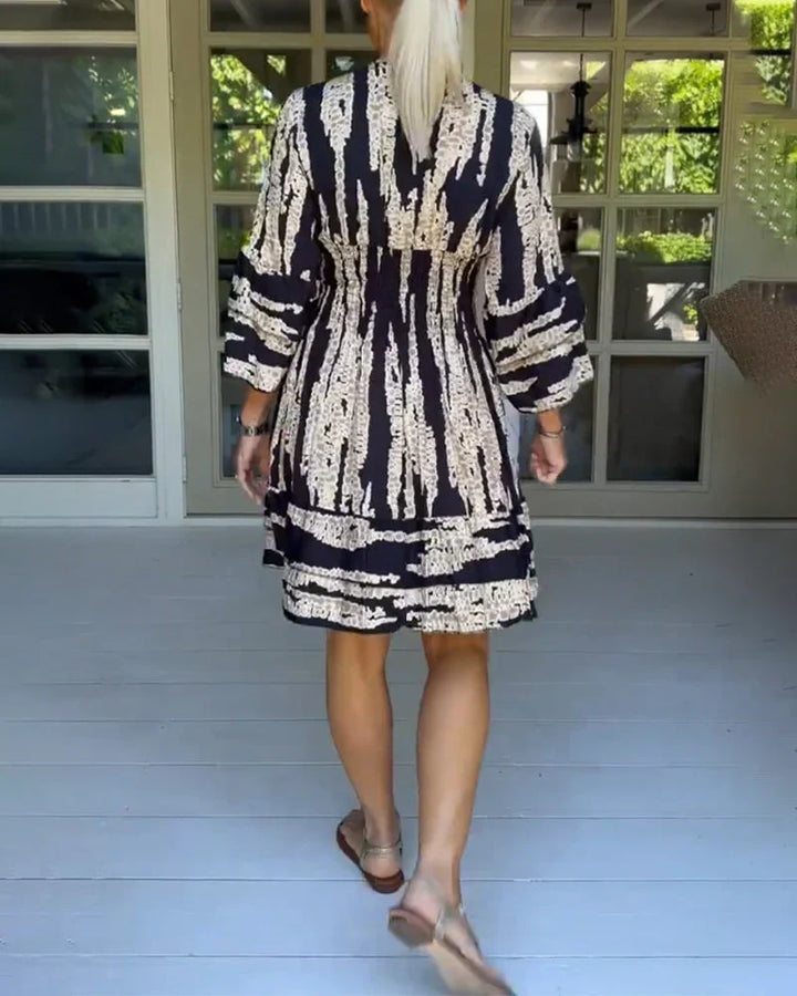 Printed women's V-neck A-line dress, 3/4 sleeves. Ideal for casual spring & autumn fashion. Flowy & stylish.